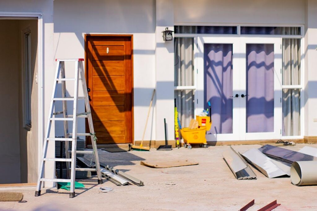 exterior of a home under renovation with a ladder placed by the door