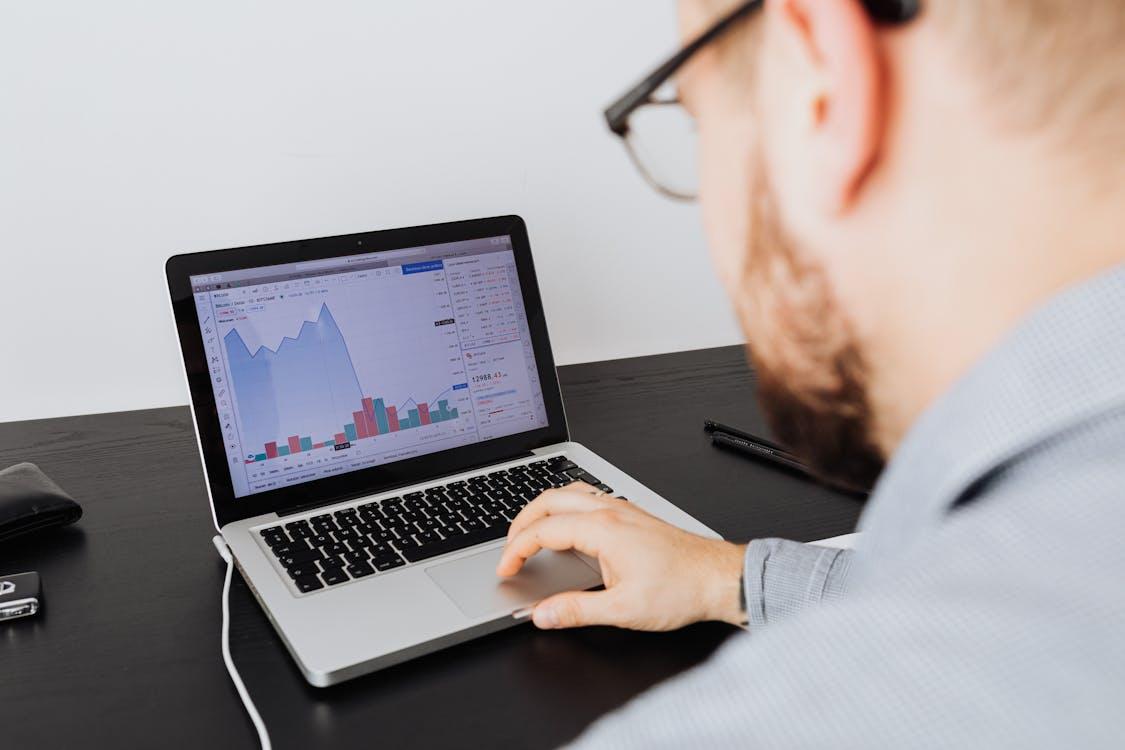 Investor analyzing rental property financial data on a laptop screen