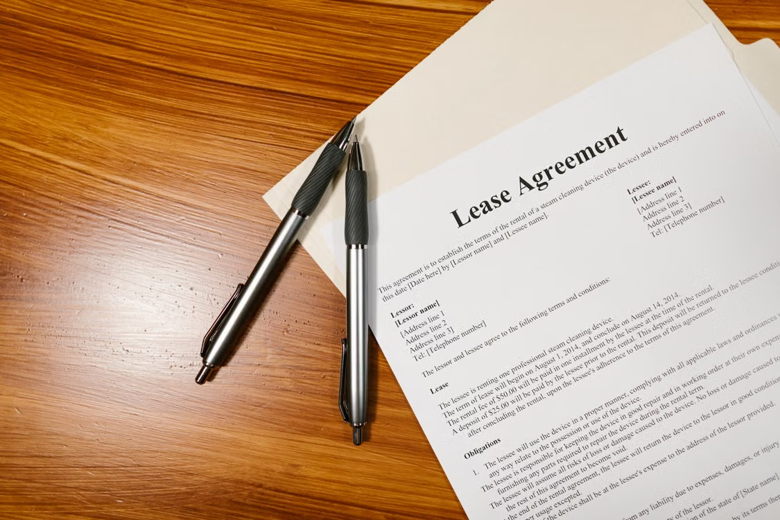 close-up of a lease agreement on a table with pens