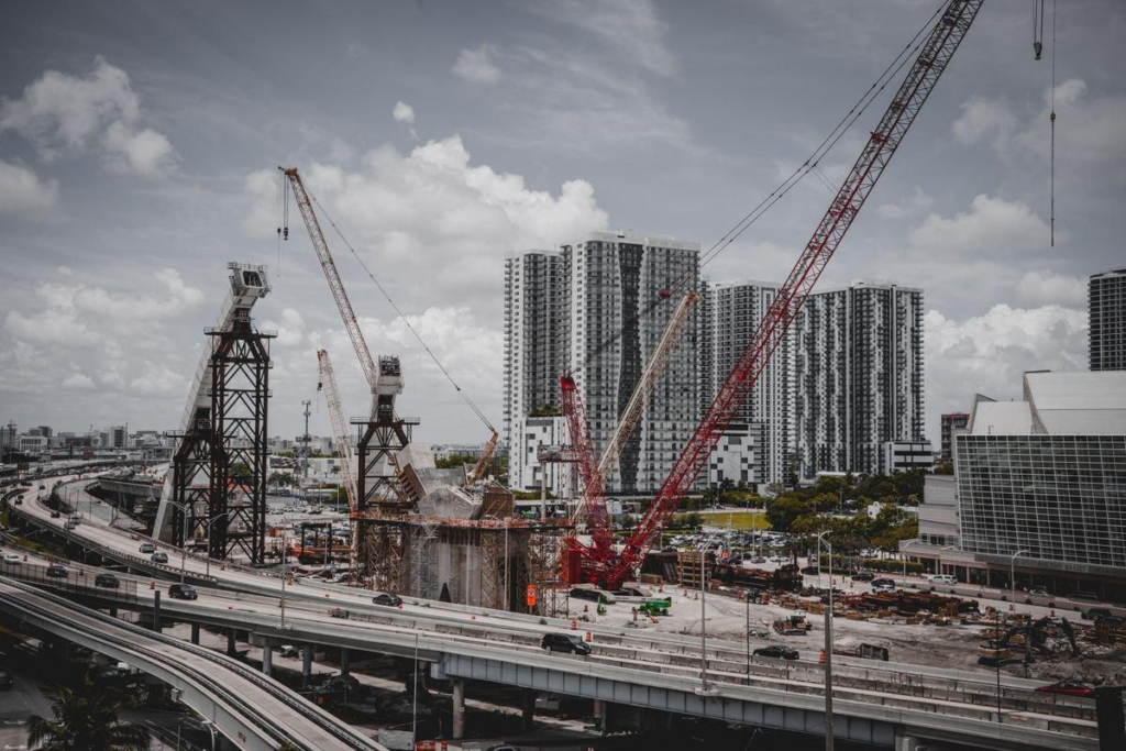 Construction cranes over a developing skyline