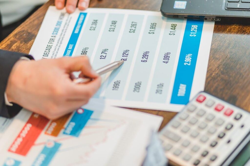 an agent pointing at real estate rates with a pen