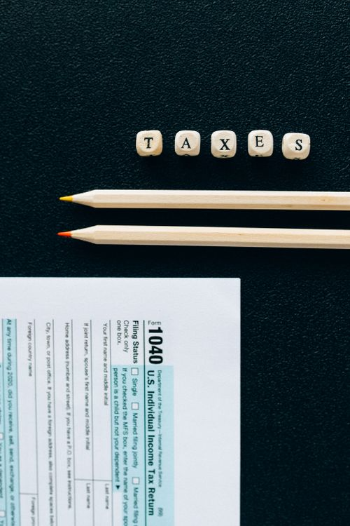 A form for tax paying is on a black surface
