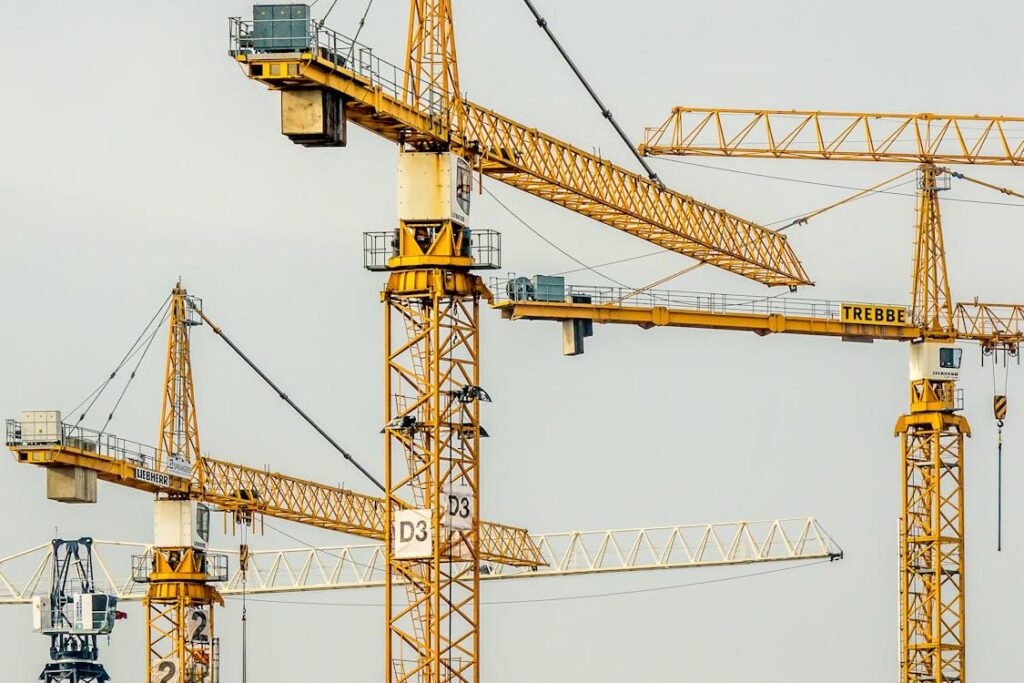 Yellow tower cranes at a construction site