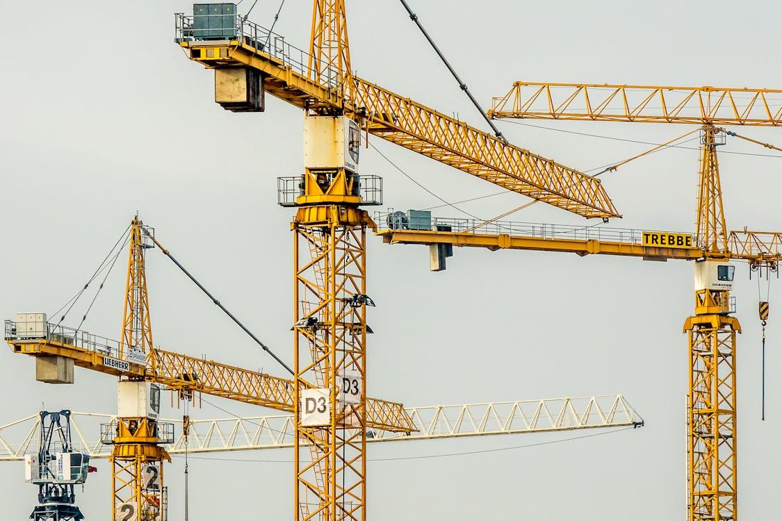 Yellow tower cranes at a construction site