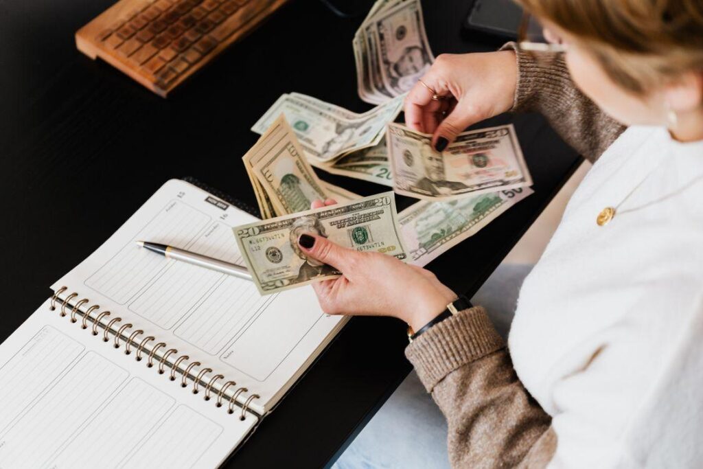 A woman is counting banknotes