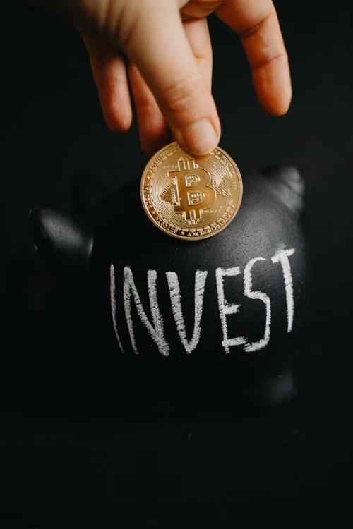 A man holding a coin, while invest is written underneath