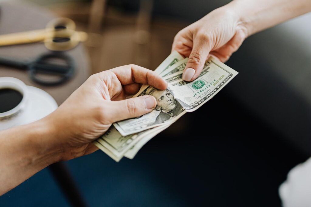 A hand is holding banknotes