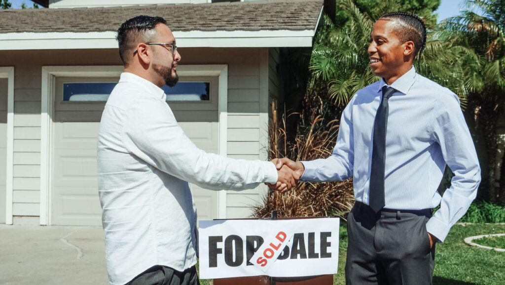 Two men shaking hands, after the new home deal