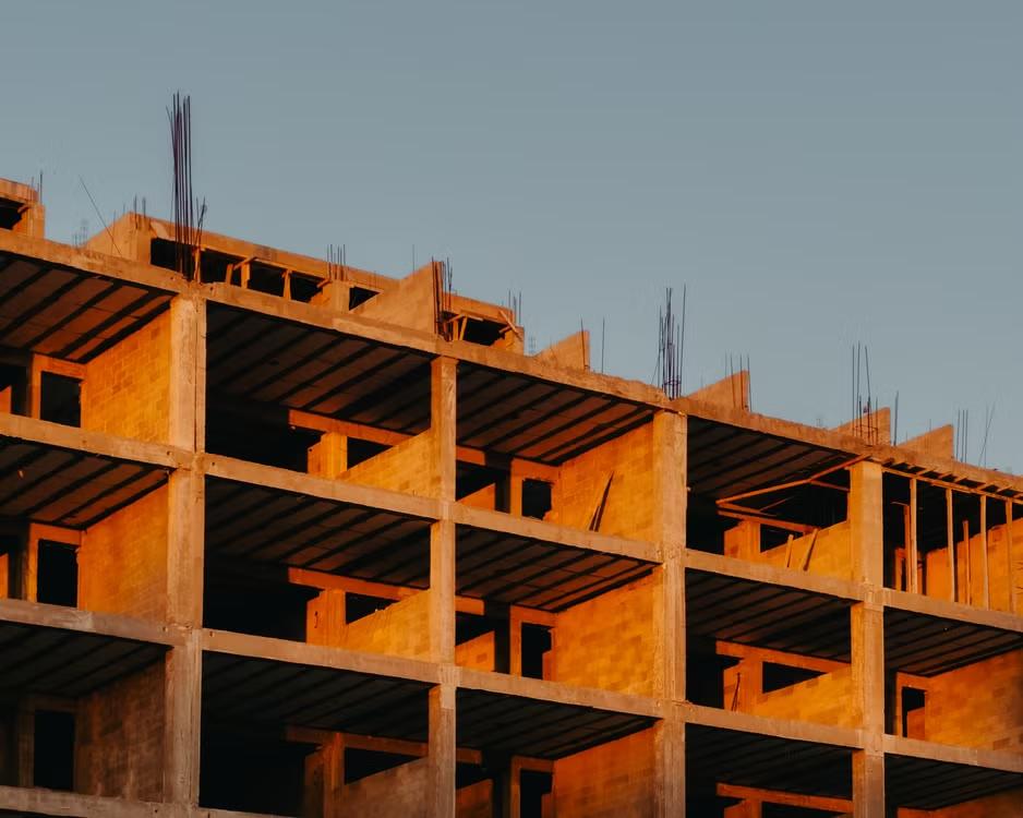 Large concrete building under construction against the sky