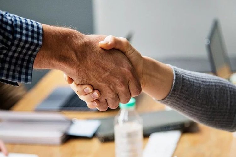 A man and woman shaking hands.